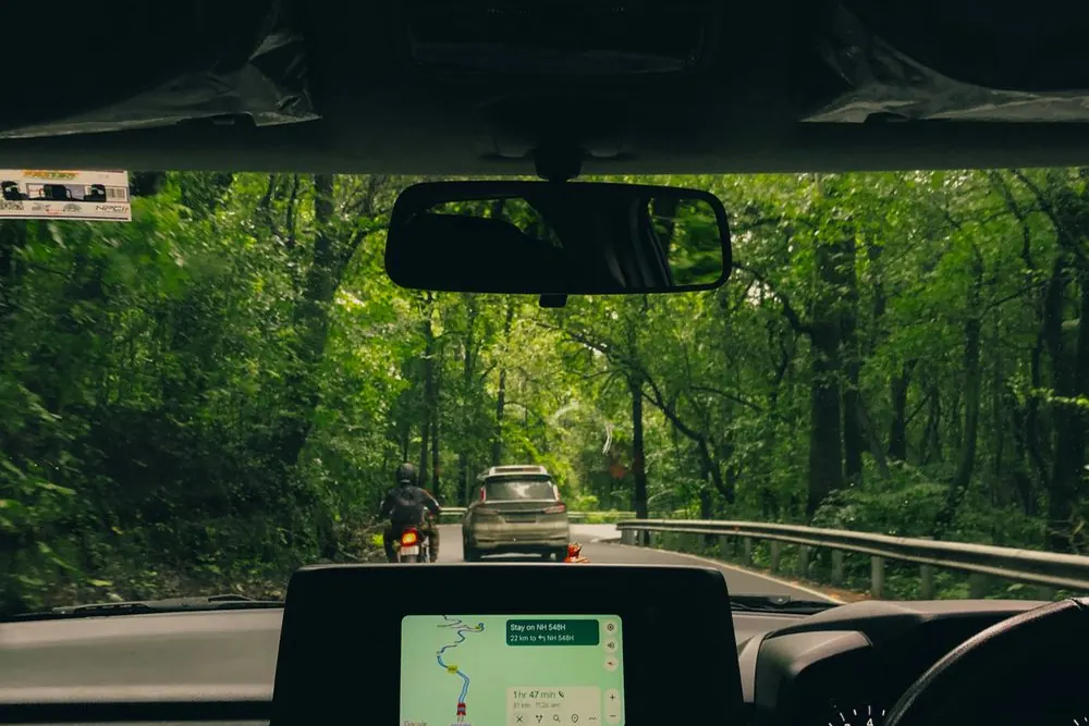 The view forward through a windscreen on an open road
