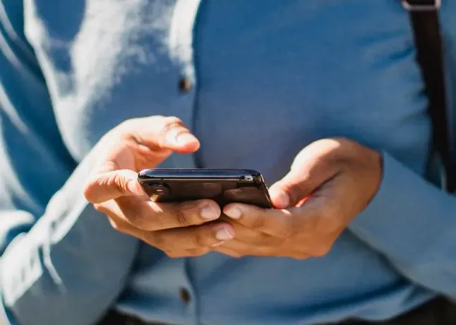 A person filling in an application on their phone